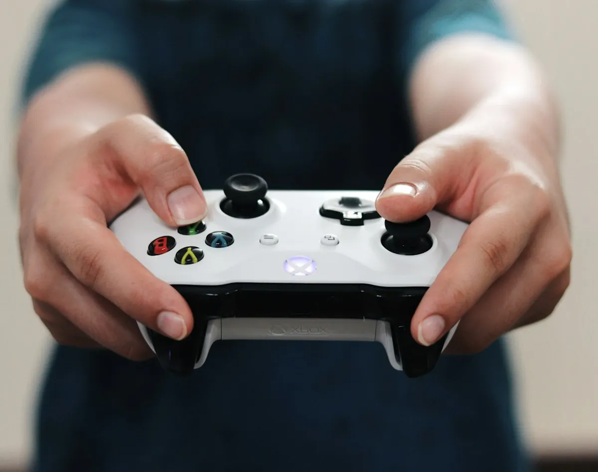 Hands holding an Xbox controller during play.